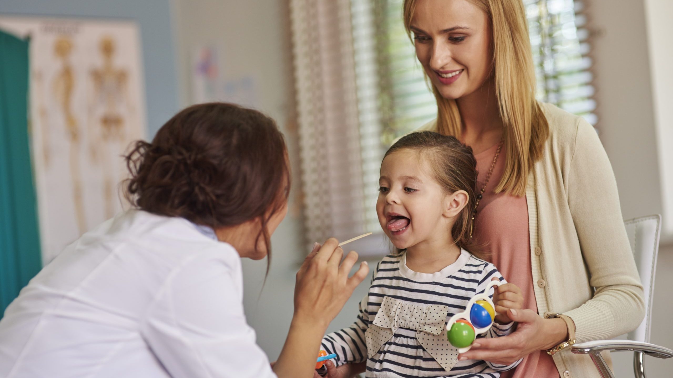 Routine examination of little girl’s throat Routine examination of little girl's throat
